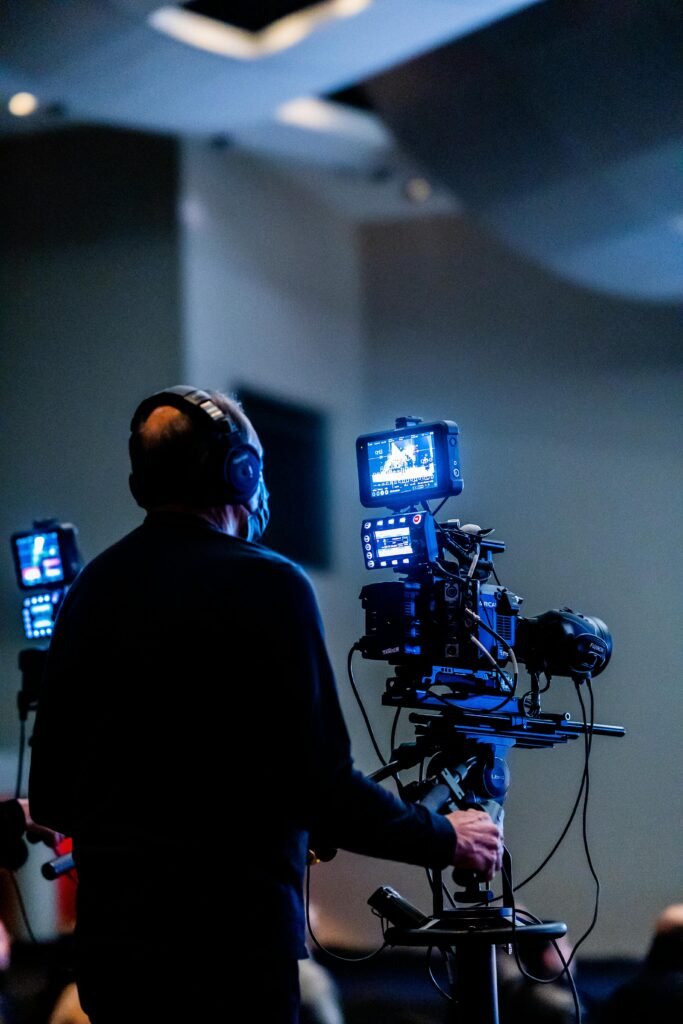 Expert cameraman recording with high-tech video camera in a studio setting.